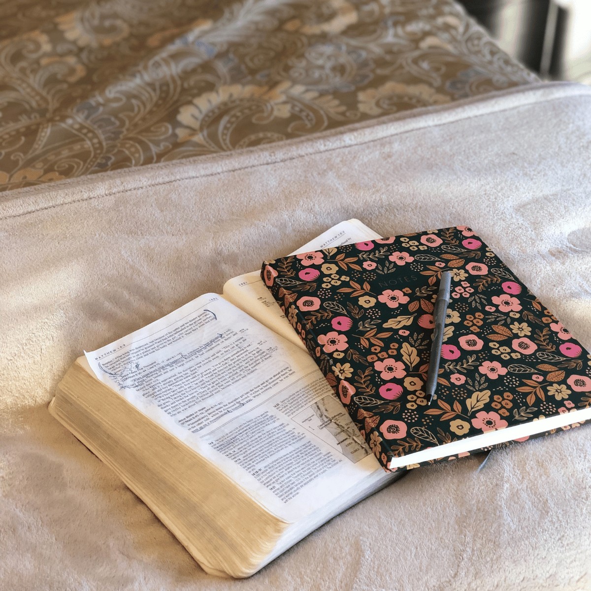 SOAP Bible Study method journal, open bible and pen on bed