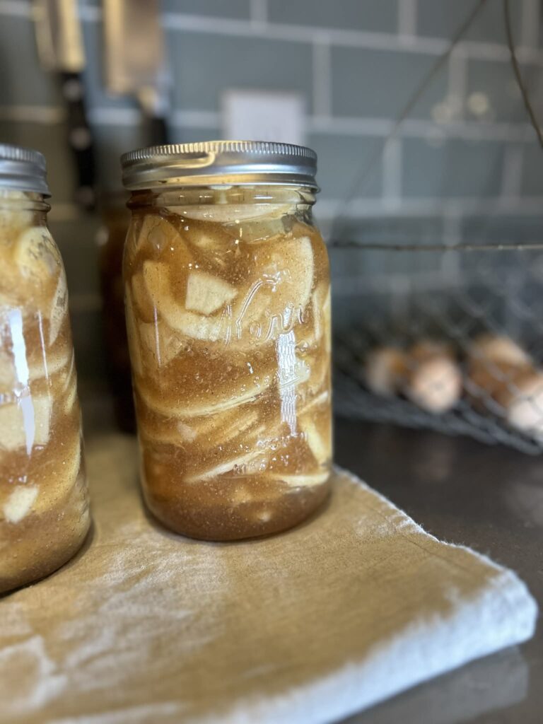 Canned Apple Pie Filling in jar cooling on the counter