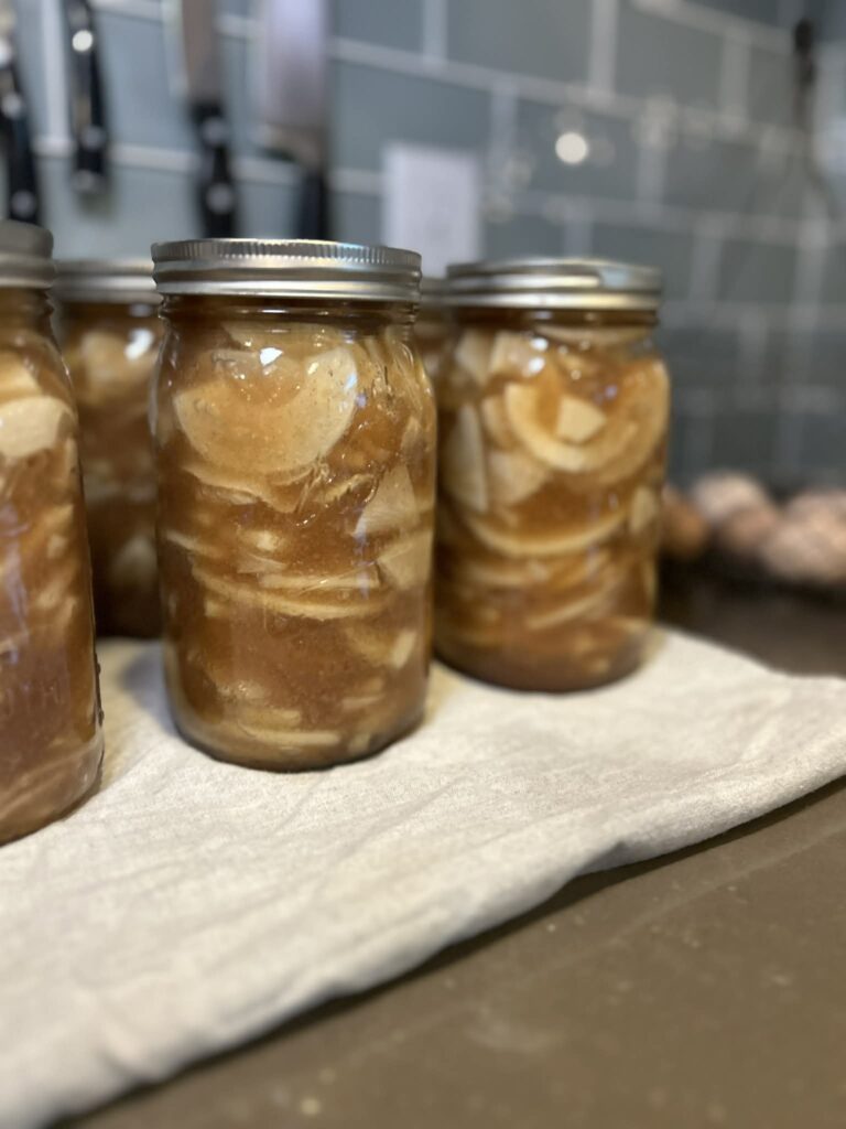 Canned Apple Pie Filling cooling on Counter