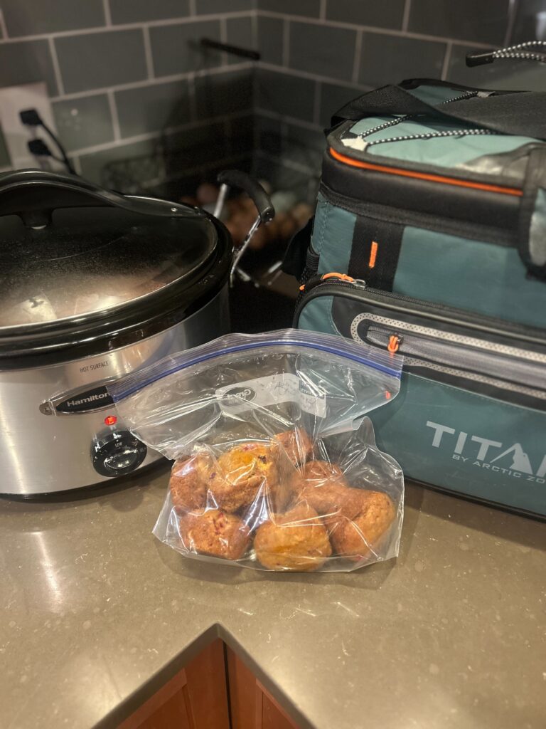 Crockpot, lunch box, and Muffins in a zip back on counter